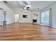 Spacious open floor plan with hardwood floors, fireplace, ceiling fan and a view of the living and dining areas at 2647 Midler Ct, Buford, GA 30519