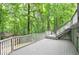 The large deck is great for entertaining and overlooks a spacious backyard with mature trees at 425 Bellflower Ct, Roswell, GA 30076