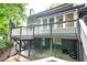 Picture of the back of the house with a large, elevated wooden deck and stone patio at 425 Bellflower Ct, Roswell, GA 30076