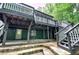 A stone patio with a full view of the deck above, stone steps and beautiful backyard at 425 Bellflower Ct, Roswell, GA 30076