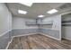 Finished basement with wood flooring, ample lighting, and wall paneling, ready for customization at 425 Bellflower Ct, Roswell, GA 30076