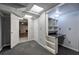 Finished basement with a built-in desk, storage, and carpeted floors, perfect for a home office at 425 Bellflower Ct, Roswell, GA 30076