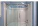 A tiled shower stall with clear sliding doors at 425 Bellflower Ct, Roswell, GA 30076