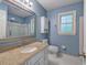 A bathroom features granite counters and updated fixtures at 425 Bellflower Ct, Roswell, GA 30076