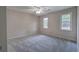Bedroom featuring two windows with natural light and neutral carpeting at 425 Bellflower Ct, Roswell, GA 30076