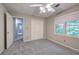 Bedroom with double closets, two windows, and neutral carpeting at 425 Bellflower Ct, Roswell, GA 30076
