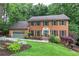 Charming two-story brick home with a well-manicured lawn and mature trees at 425 Bellflower Ct, Roswell, GA 30076
