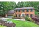Two-story brick home with green trim, shutters, and attached garage at 425 Bellflower Ct, Roswell, GA 30076