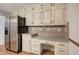 Kitchen workspace with desk, stainless fridge and updated backsplash at 425 Bellflower Ct, Roswell, GA 30076
