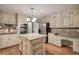 Well-equipped kitchen with stainless appliances, island and custom cabinetry at 425 Bellflower Ct, Roswell, GA 30076