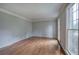 Bright living room featuring hardwood floors, neutral paint, and large windows at 425 Bellflower Ct, Roswell, GA 30076