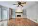 Spacious living room features a brick fireplace, built-in shelving, and hardwood floors at 425 Bellflower Ct, Roswell, GA 30076