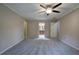 Spacious main bedroom featuring a ceiling fan, and access to the main bathroom at 425 Bellflower Ct, Roswell, GA 30076