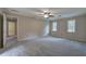 Spacious main bedroom featuring a ceiling fan, and access to a bathroom at 425 Bellflower Ct, Roswell, GA 30076