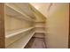 Walk-in pantry with many white shelves, and tile flooring at 425 Bellflower Ct, Roswell, GA 30076