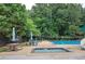 Community swimming pool and splash pad surrounded by picnic tables at 425 Bellflower Ct, Roswell, GA 30076