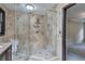 Bathroom showcasing a tiled shower with glass door and view into adjacent bedroom at 425 Bellflower Ct, Roswell, GA 30076