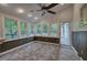 Cozy sunroom with wainscotting, many windows, and tile flooring at 425 Bellflower Ct, Roswell, GA 30076