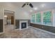 Sunroom with fireplace, many windows with a view of the trees, and tile flooring at 425 Bellflower Ct, Roswell, GA 30076