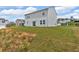 View of backyard featuring an attached home with gray siding, an expansive green yard, and an open view at 600 Tudor St, Kingston, GA 30145