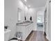 Clean bathroom features double sinks with granite countertops, vinyl flooring, and access to the bedroom at 600 Tudor St, Kingston, GA 30145