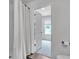 Clean bathroom includes a toilet, shower with curtain, and view to the bedroom with natural light at 600 Tudor St, Kingston, GA 30145