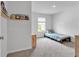Bright bedroom features a single bed, storage shelf, plush carpets and a sunny window at 600 Tudor St, Kingston, GA 30145
