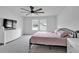 This bedroom offers natural light, plush carpets, a modern dresser with a flat screen TV and a comfortable bed at 600 Tudor St, Kingston, GA 30145