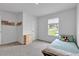 Bright bedroom features a single bed, modern dresser, plush carpets, and a sunny window overlooking the neighborhood at 600 Tudor St, Kingston, GA 30145
