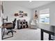 Well-lit bedroom featuring a large window, plush chair, desk, and a guitar mounted on the wall at 600 Tudor St, Kingston, GA 30145