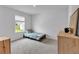 Bright bedroom features a single bed, modern dresser, plush carpets, and a sunny window overlooking the outdoors at 600 Tudor St, Kingston, GA 30145
