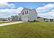 Two-story home with a large garage, light gray siding and black shutters at 600 Tudor St, Kingston, GA 30145