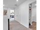 Upstairs hallway with access to bedrooms, bathrooms, and laundry room at 600 Tudor St, Kingston, GA 30145