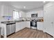 Modern kitchen with granite countertops, stainless steel appliances, and wood floors at 600 Tudor St, Kingston, GA 30145