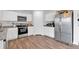 Modern kitchen with granite countertops, stainless steel appliances, and wood floors at 600 Tudor St, Kingston, GA 30145