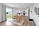 Open-concept kitchen with stainless steel appliances, wood floor, and natural light at 600 Tudor St, Kingston, GA 30145
