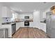 Modern kitchen with granite countertops, stainless steel appliances, and wood floors at 600 Tudor St, Kingston, GA 30145