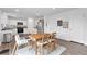 Kitchen with stainless steel appliances, wood floor, and dining area at 600 Tudor St, Kingston, GA 30145
