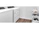 Bright laundry room featuring new washer and dryer, plus a cleaning supply cart at 600 Tudor St, Kingston, GA 30145