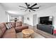 Open-concept living area with a leather sectional couch and TV at 600 Tudor St, Kingston, GA 30145