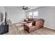 Living room with a leather sectional couch, TV, and ceiling fan at 600 Tudor St, Kingston, GA 30145