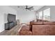 Living room with a leather sectional couch, TV, and ceiling fan at 600 Tudor St, Kingston, GA 30145