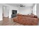 Living room with a leather sectional couch, TV, and ceiling fan at 600 Tudor St, Kingston, GA 30145