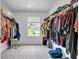 Spacious walk-in closet has custom shelving, ample storage, plush carpeting, and a window for natural light at 600 Tudor St, Kingston, GA 30145