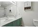 Bright bathroom featuring a shower-tub combo, toilet, and a dual sink vanity with cabinet storage at 1536 Liberty Nw Pkwy, Atlanta, GA 30318
