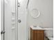Bathroom featuring a standing shower, vanity with storage, and a round mirror at 1536 Liberty Nw Pkwy, Atlanta, GA 30318