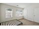 This bedroom has a neutral carpet, two windows with blinds, and white walls at 1536 Liberty Nw Pkwy, Atlanta, GA 30318