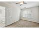Bedroom with en suite bathroom, carpet, ceiling fan, and window providing natural light at 1536 Liberty Nw Pkwy, Atlanta, GA 30318