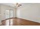 Bright bedroom features hardwood floors, ceiling fan, and balcony access, creating a cozy retreat at 1536 Liberty Nw Pkwy, Atlanta, GA 30318