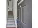 Cozy entryway with stairs, gray carpet, white banister and a black front door at 1536 Liberty Nw Pkwy, Atlanta, GA 30318